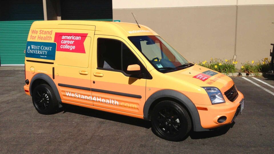 Bright yellow and orange Ford Transit vehicle graphics for American Career College