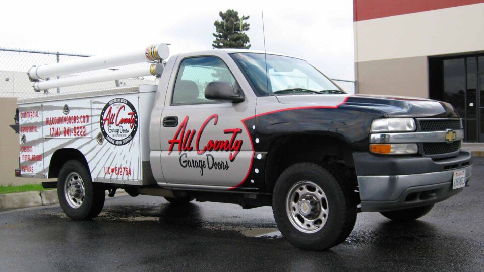 Full Utility Truck Wrap covering the truck cab and utility box in back with red, black and white graphics