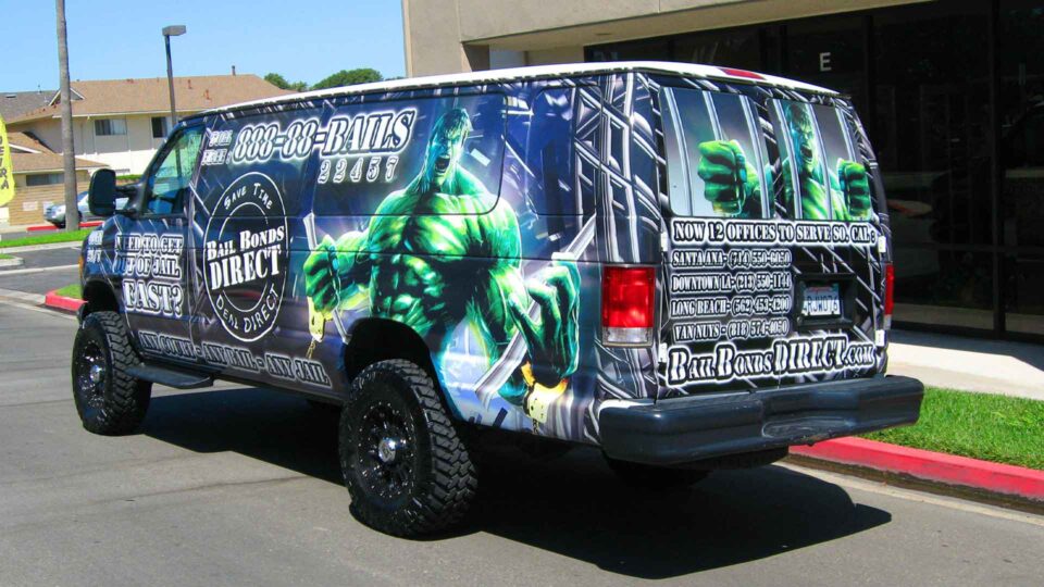 Loud vehicle wrap featuring a Hulk type character breaking out of jail cell promoting Bail Bonds Direct
