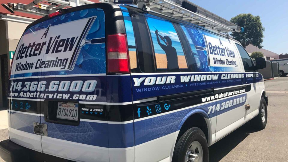 Blue 3/4 Chevy Van wrap with logos and image of person cleaning windows for Better View Window Cleaning
