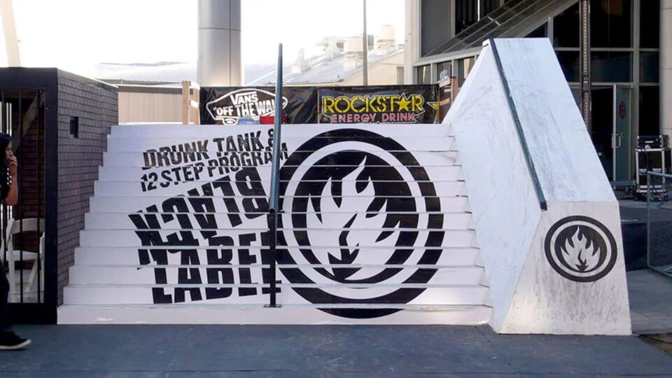 White stairs with black vinyl floor graphic of Black Label flame logo and text