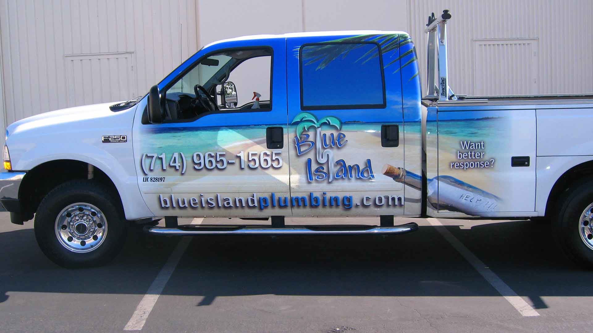 mid section of F250 wrapped with beach scene and Blue Island Plumbing Logo