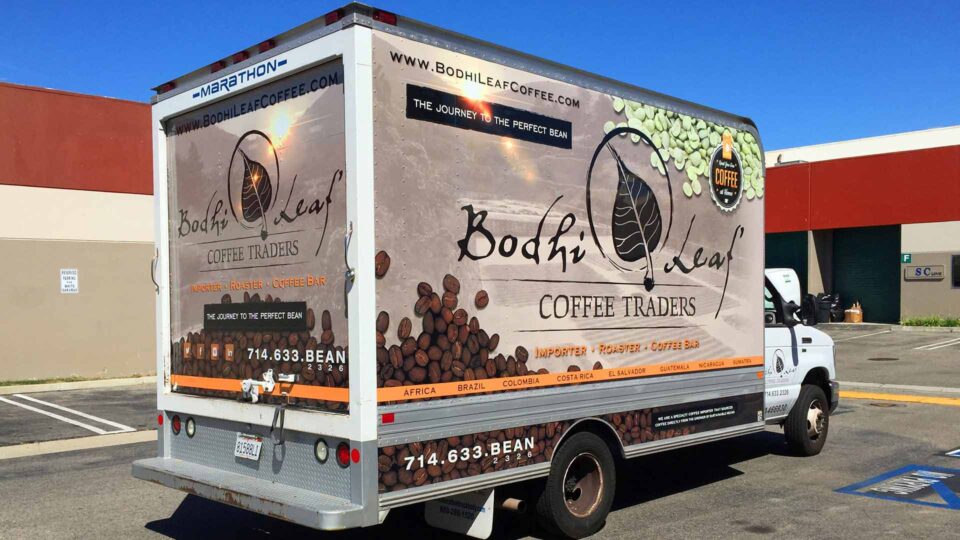 Full box truck wrap featuring coffee beans with a subdued landscape of Brazil