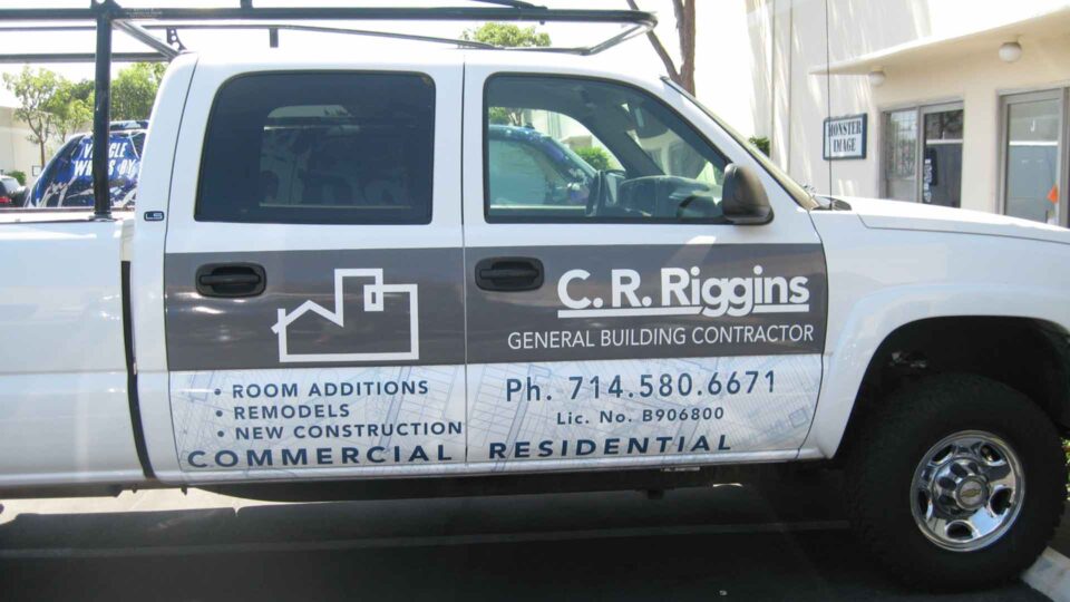 White Chevy partial work truck wrap with house logo and CR RIGGINS contractor info in gray and blue