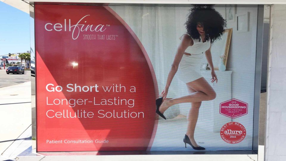 Solid Window Vinyl Graphics for Cellfina showing woman with bare legs and red background with logo