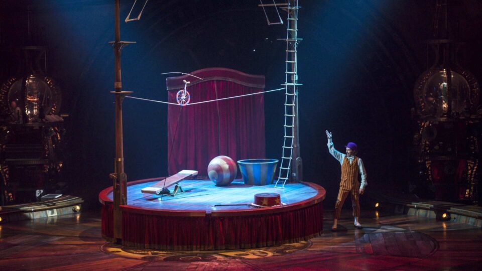 Round Circus stage with blue vinyl floor graphics showing a performer and ladder and tightrope