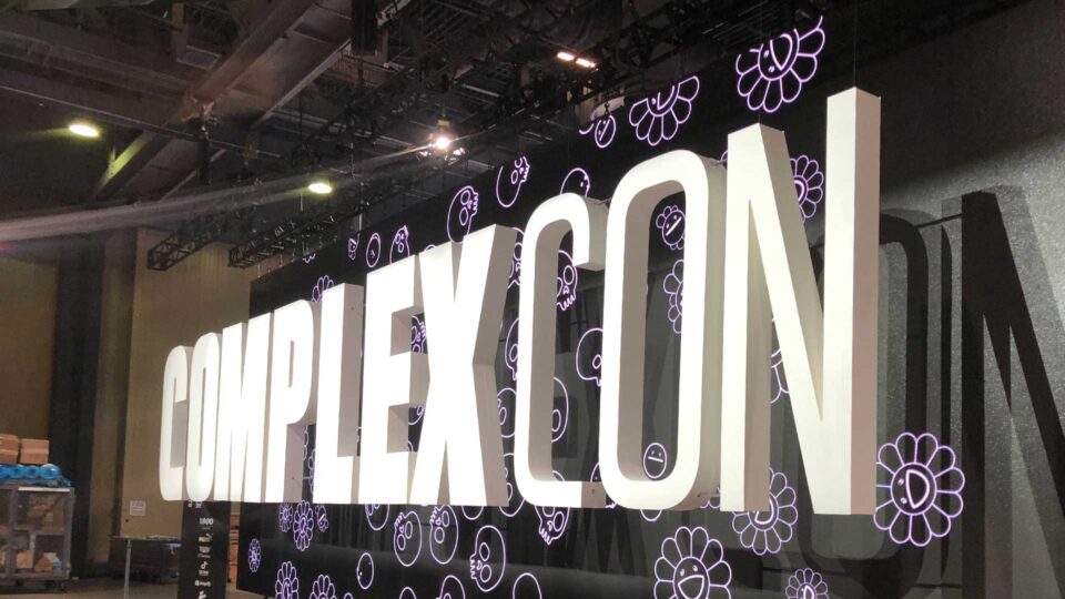 Large white router cut letters that say Complexicon for trade show