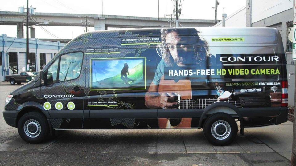 Sprinter van wrap featuring surfing image, man playing guitar and maps of Indonesia for Contour Cameras