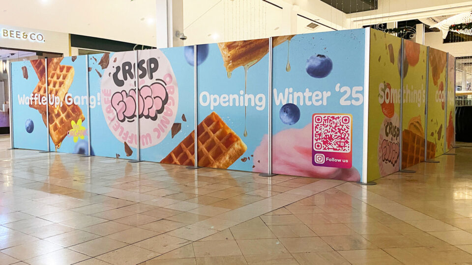 Blue wall graphic with images of waffles, berries and Crisp N Fluff text