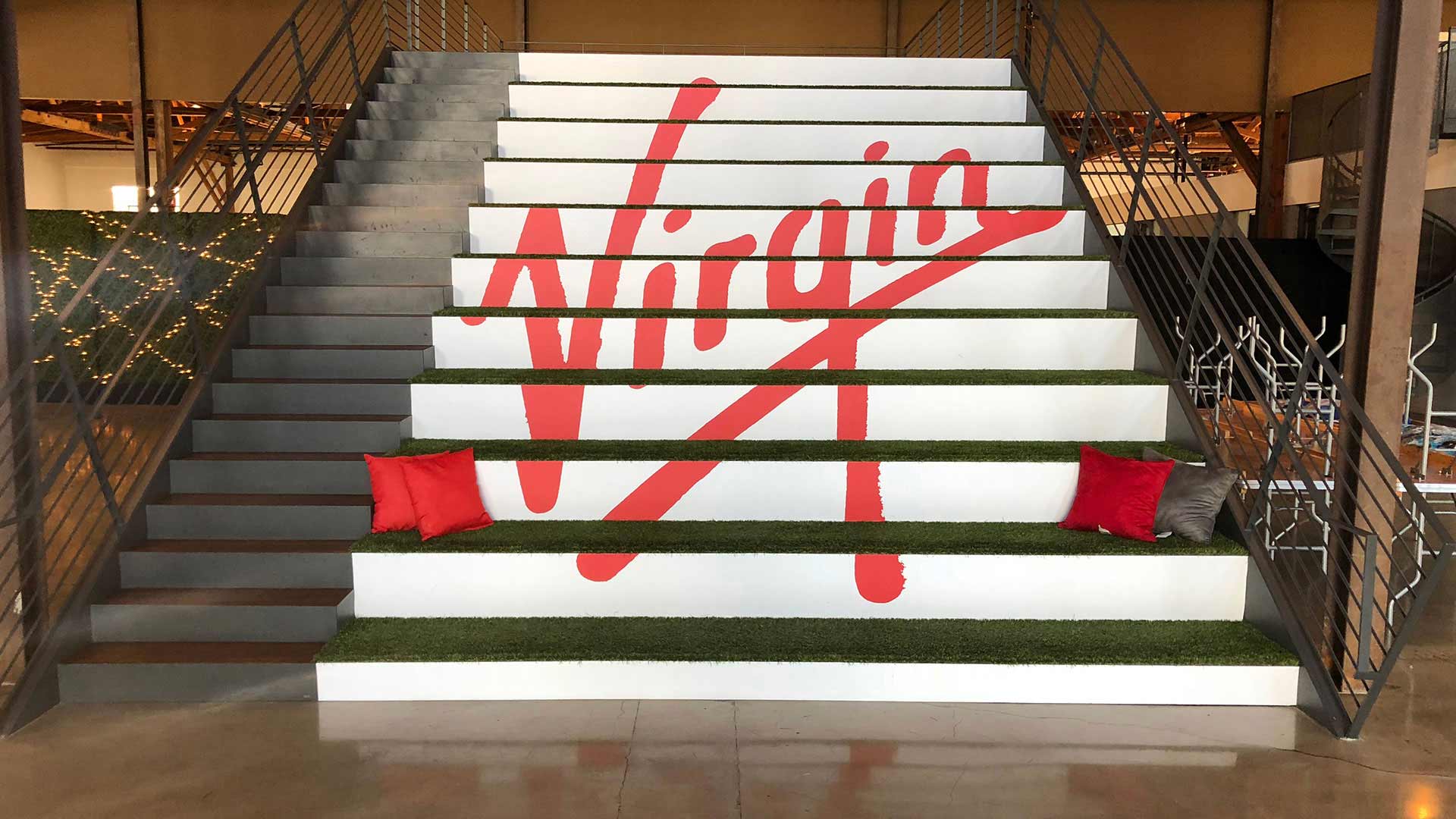 Concrete Stairs with white vinyl stair graphic that says Virgin in red