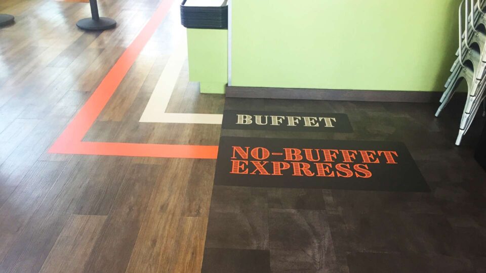 Orange and white stripe die cut floor decals that direct towards Buffect and No Buffet Express