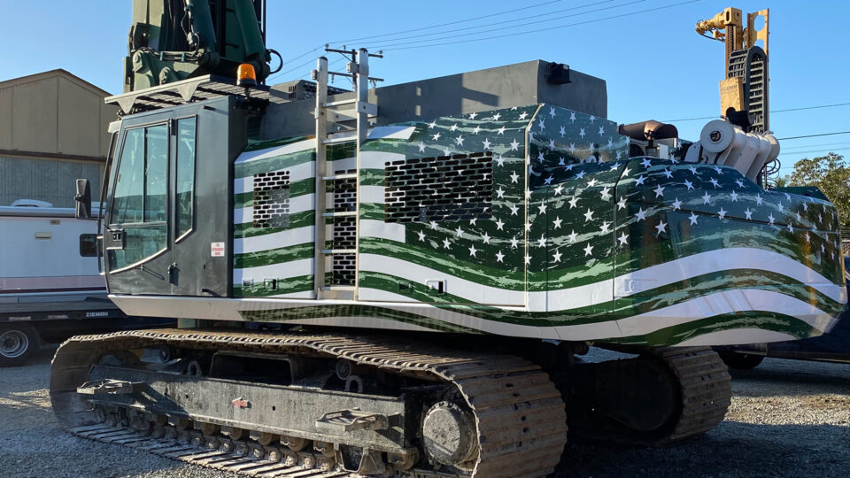 Green and white american flag vinyl graphics on Drilling Rig in parking lot