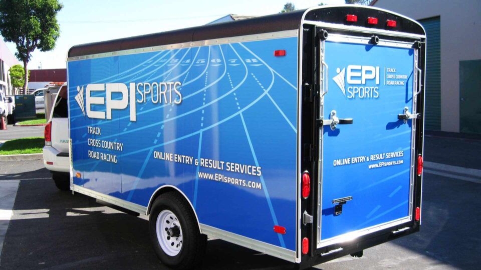 Blue enclosed trailer full wrap featuring a racing track for EPI Sports