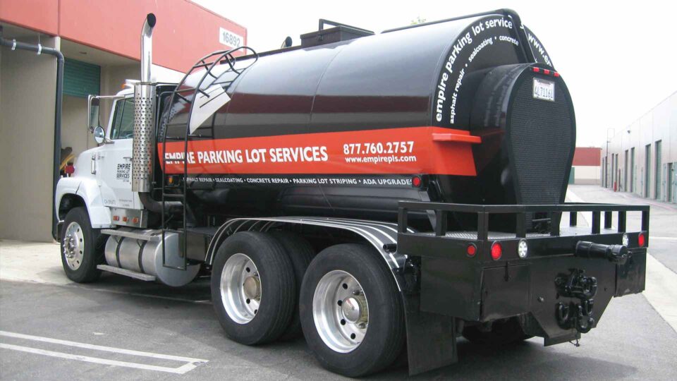 Black tanker truck with List of Services on a red stripe- partial wrap