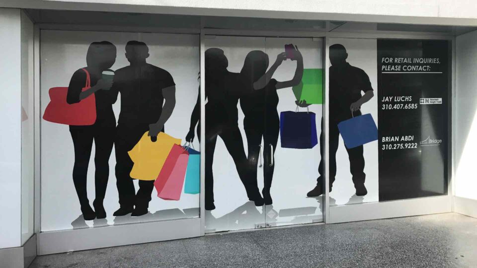 Solid vinyl window graphics for space for lease showing people shopping with bright bags