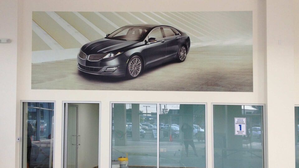 wall graphic of gray Ford car at Ford Dealership