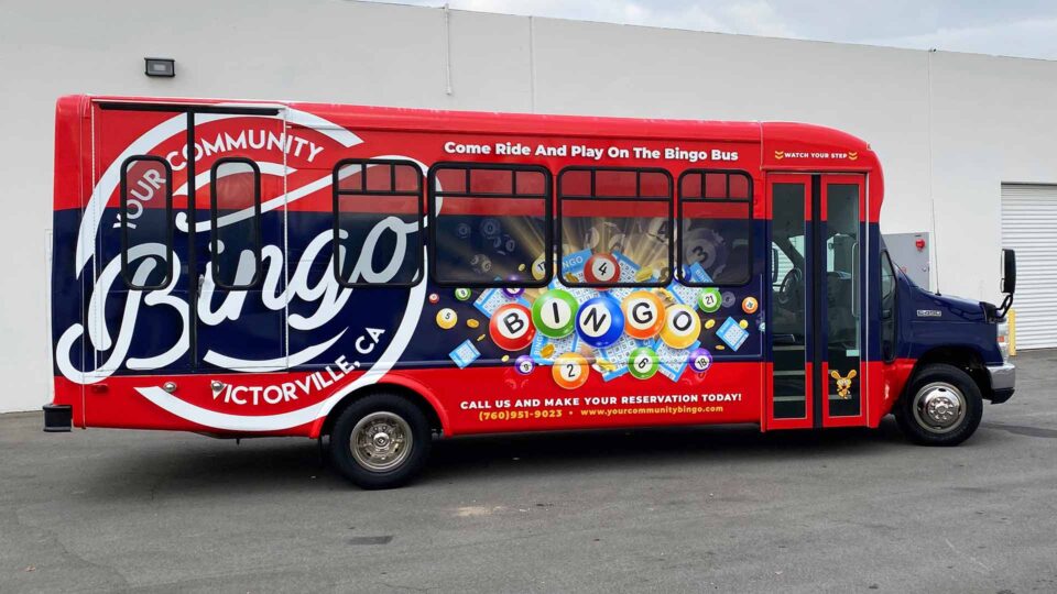 Red shuttle bus wrap showing BINGO imagery
