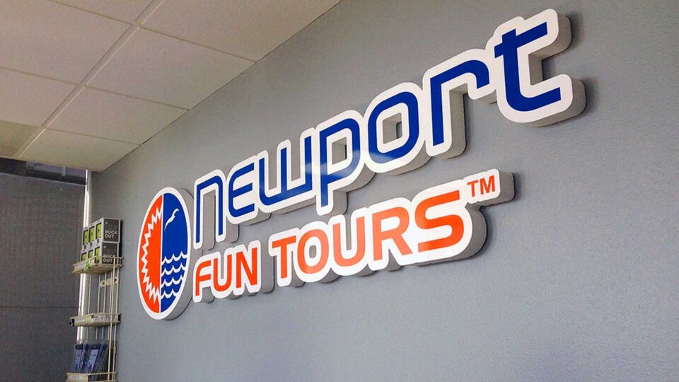 Orange, blue and white router cut indoor wall sign for Newport Fun Tours