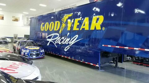 Blue semi truck trailer wrap with GoodYear Racing logo on side