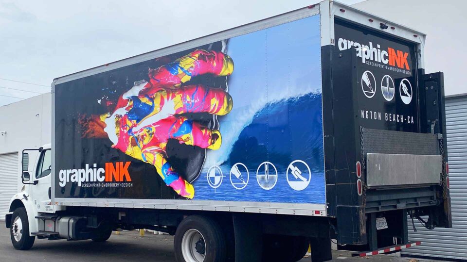 Colorful 24 foot trailer wrap with image of wave and bright paint splatter hand for Graphic Ink