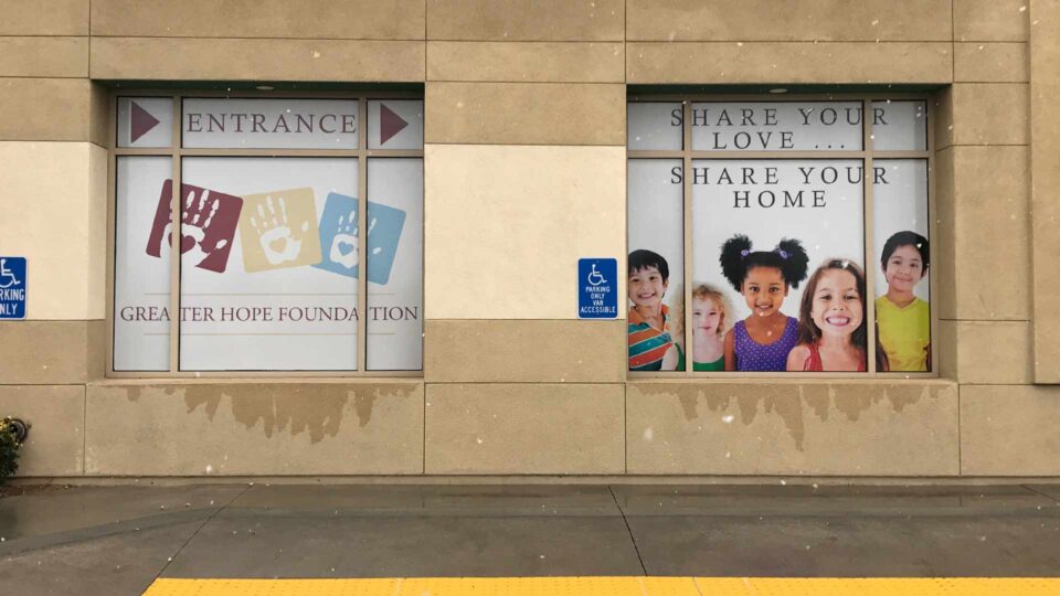 White solid window graphic with Children and handprints for Greater Hope Foundation