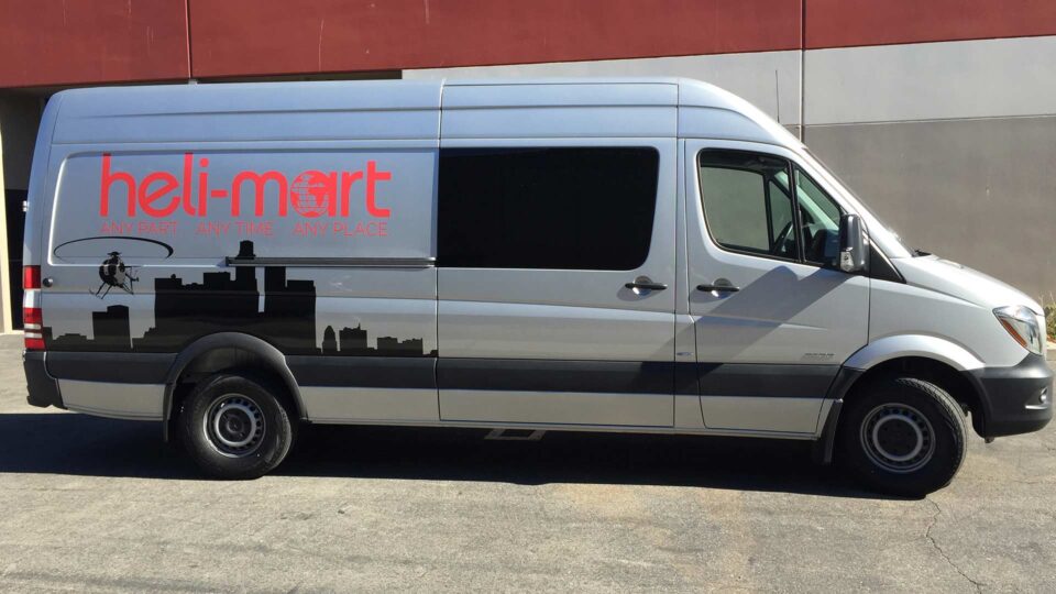 Partial Sprinter wrap for Helimart featuring helicopter over black skyline