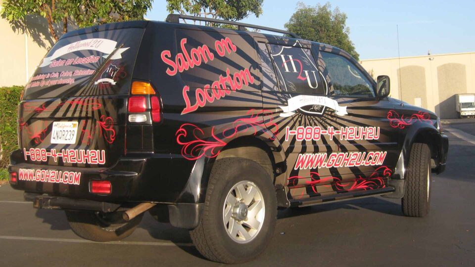 Full SUV wrap with Salon info in red and white.