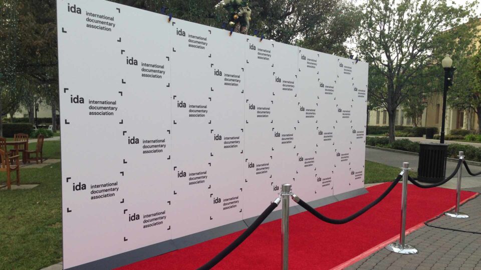 White step & repeat wall with black IDA logo on red carpet for special event