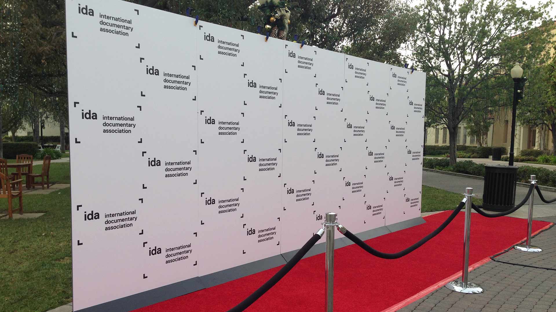 White step & repeat wall with black IDA logo on red carpet for special event