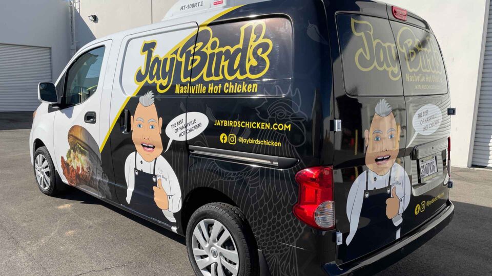 Black partial Nissan van wrap with chicken sandwich and chef for Jaybirds Nashville Hot Chicken