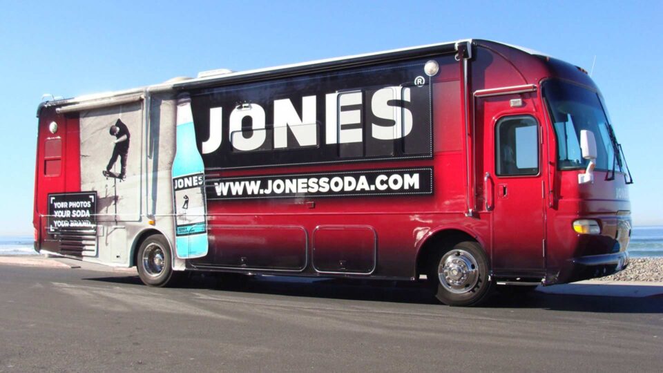Red RV wrap with image of skateboarder and Jones Soda