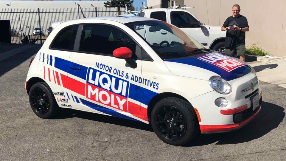 Red, white and blue partial Ford Fiesta Vehicle wrap with Liqui Moly logo diagnolly across sides