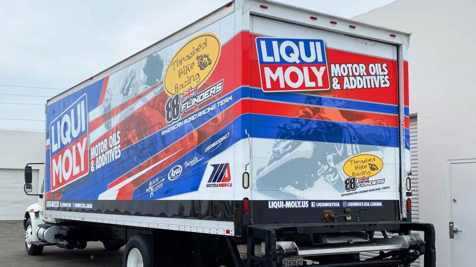 red, white and blue truck wrap for Liqui moli racing