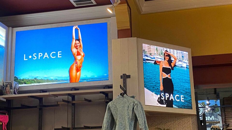 2 illuminated light boxes with images of girls in bikini and clothing for Lspace Swim.