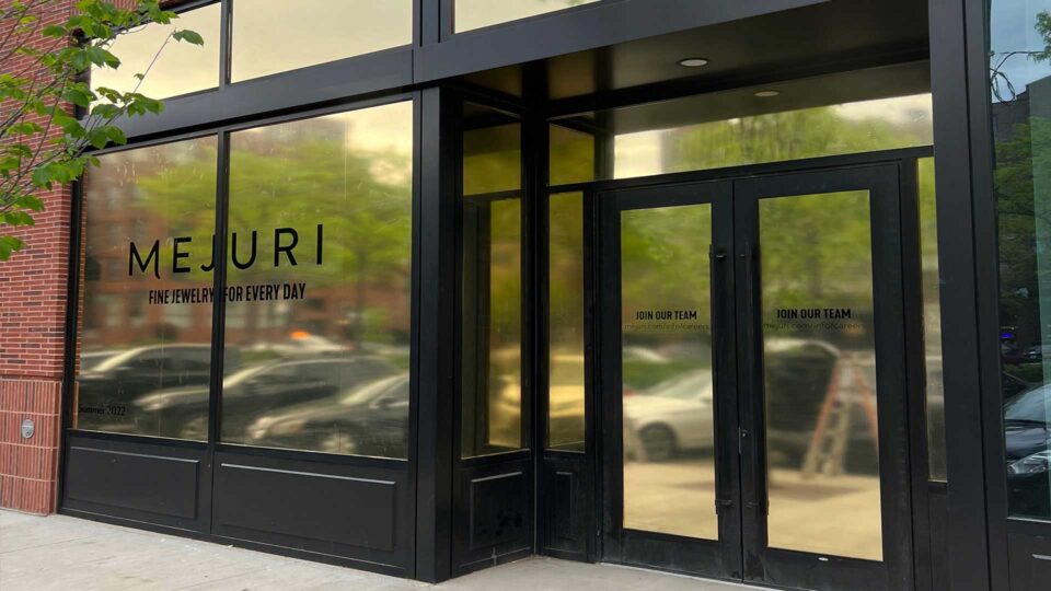 Gold windows with black Mejuri Logo