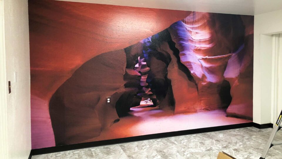 Red tone wall graphic of Moab Canyon in office