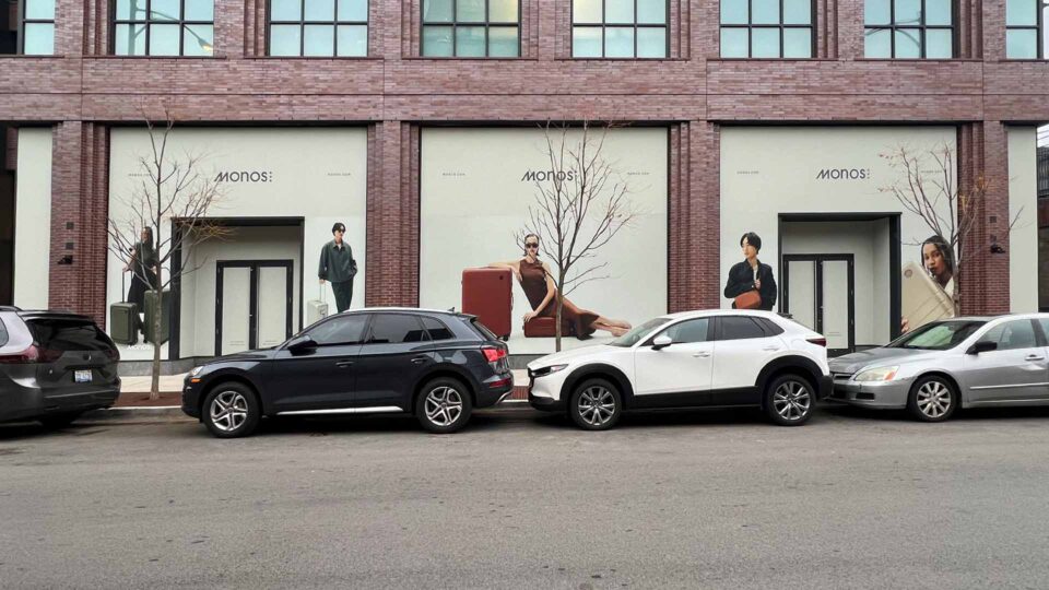 White solid window graphics featuring people with Monos luggage