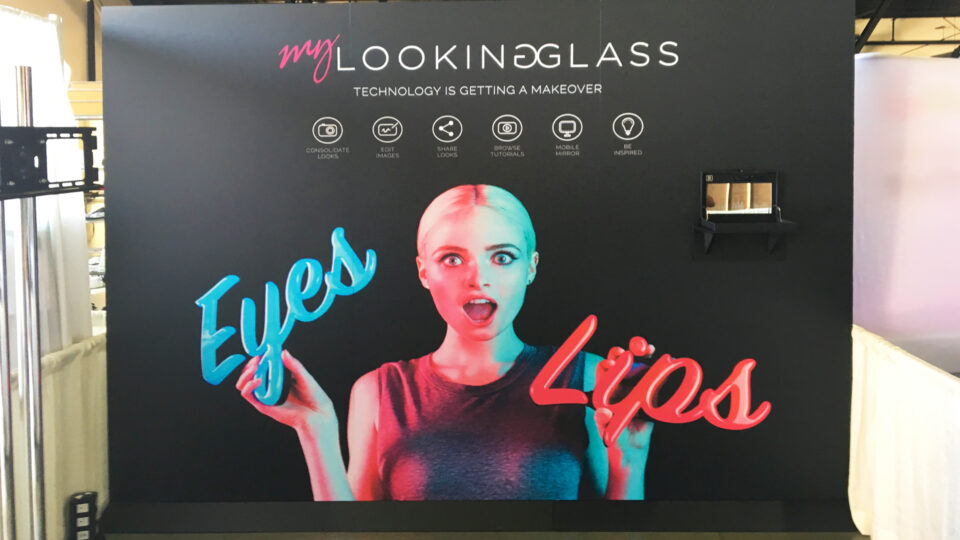 Black wall graphic with woman and the words eyes and lips in blue and red