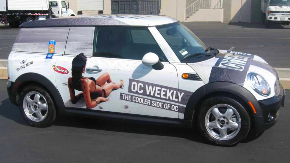 White mini cooper wrap with girl on the beach for OC weekly