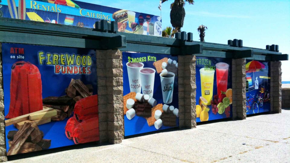 Colorfull outdoor wall graphics showing food, firewood and beach rentals