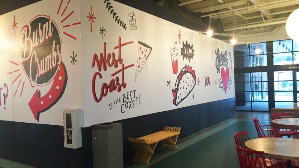 White, red and black Burnt Crumbs Coming Soon restaurant barricade with images of pizza, tacos and heart
