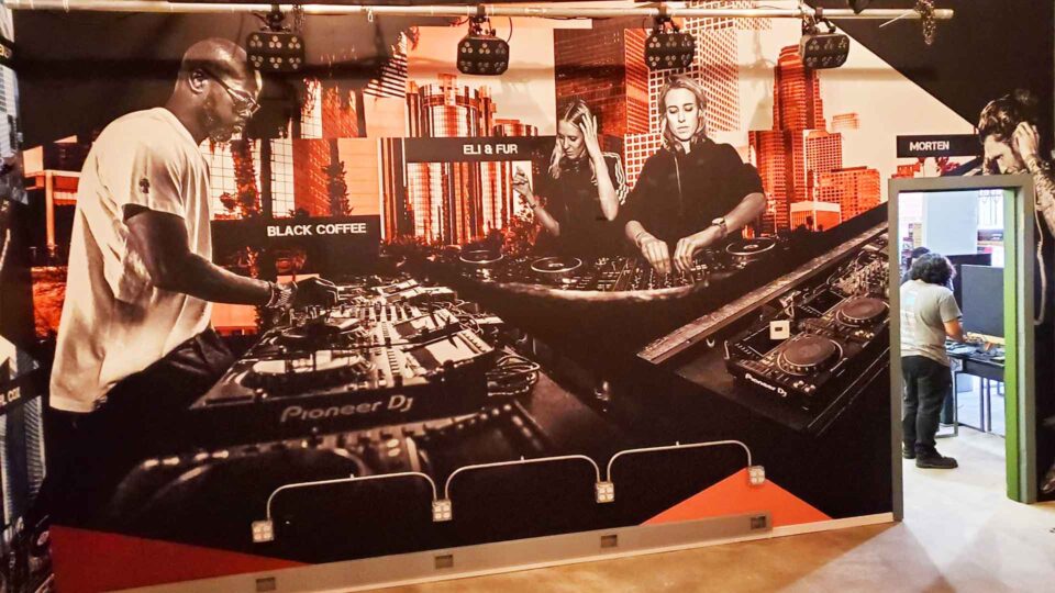 wall mural of 3 dj's using Pioneer DJ equipment