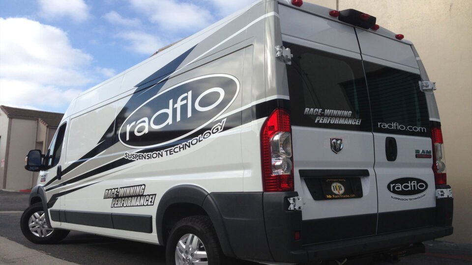 White, black and gray partial wrap with stripes and Radflow Suspension logo