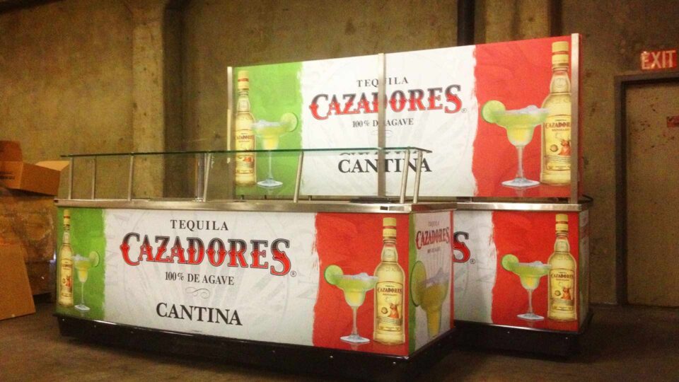 Red, white and green stripe concession stand graphics with Cazadores Tequila bottles, text and margarita
