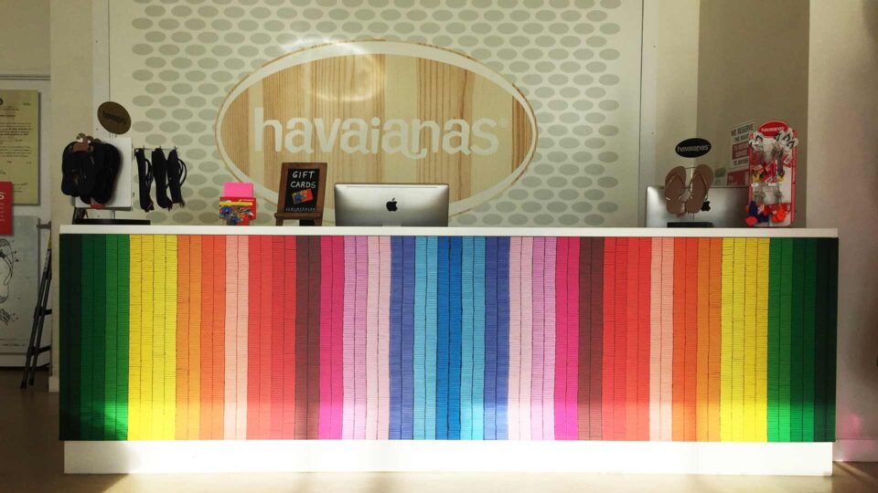 Retail Counter for Havaianas with rainbow colors and round logo on back wall