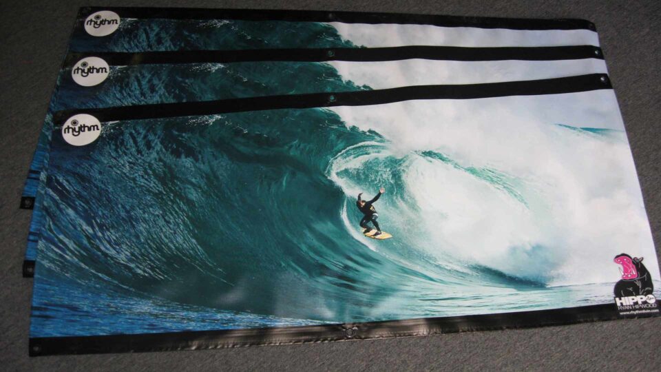 3 banners with a surfer dropping in on big wave that have Rhythm and Hippo Logos