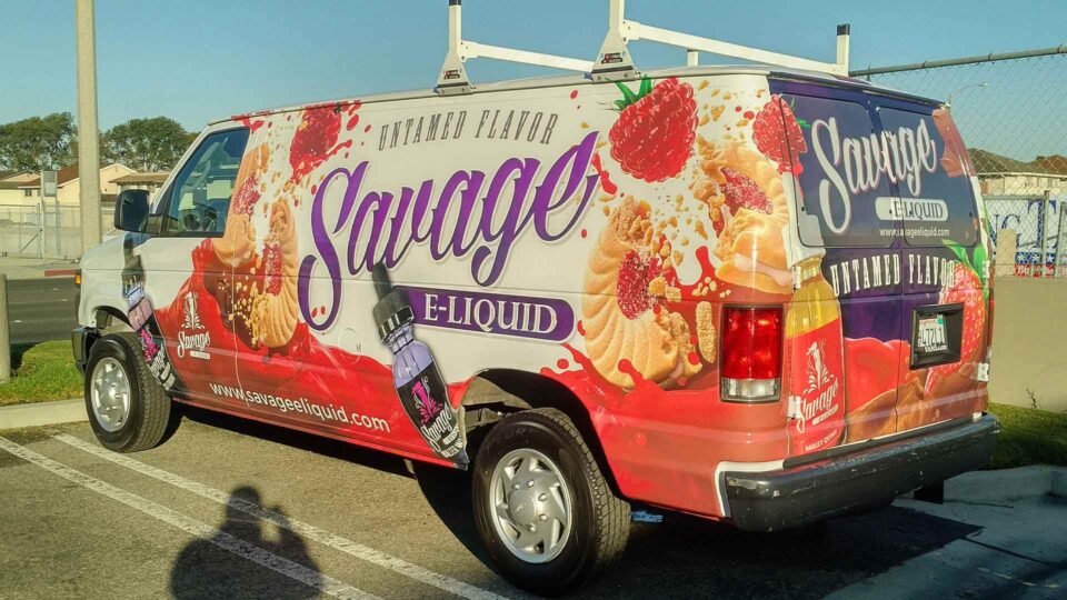 Van wrap with images of raspberries, cookies and Savage E Liquid bottles.