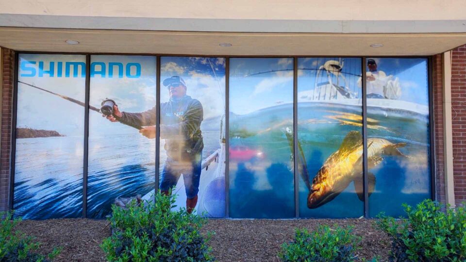 Colorful window graphic with men fishing and undsea view of fish