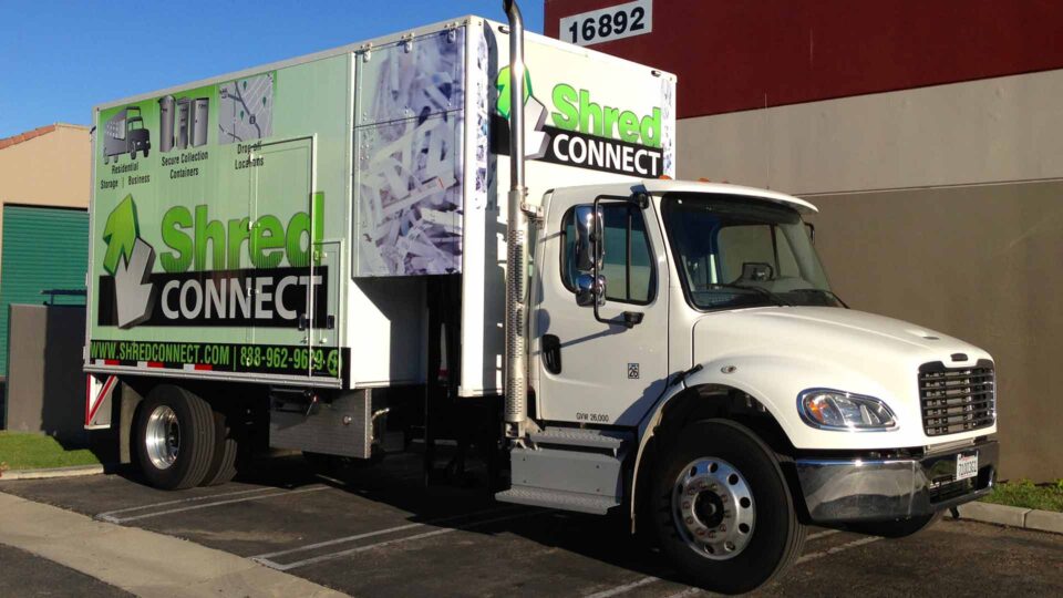 Green, white and black Shred Connect logo and paper shredding graphic on box truck wrap