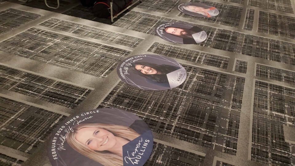 Walk of Fame Round floor graphics featuring photo and name of award winning realtor